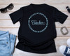 Teacher Circle Graphic T-Shirt | Black Teacher Appreciation Shirt lying flat