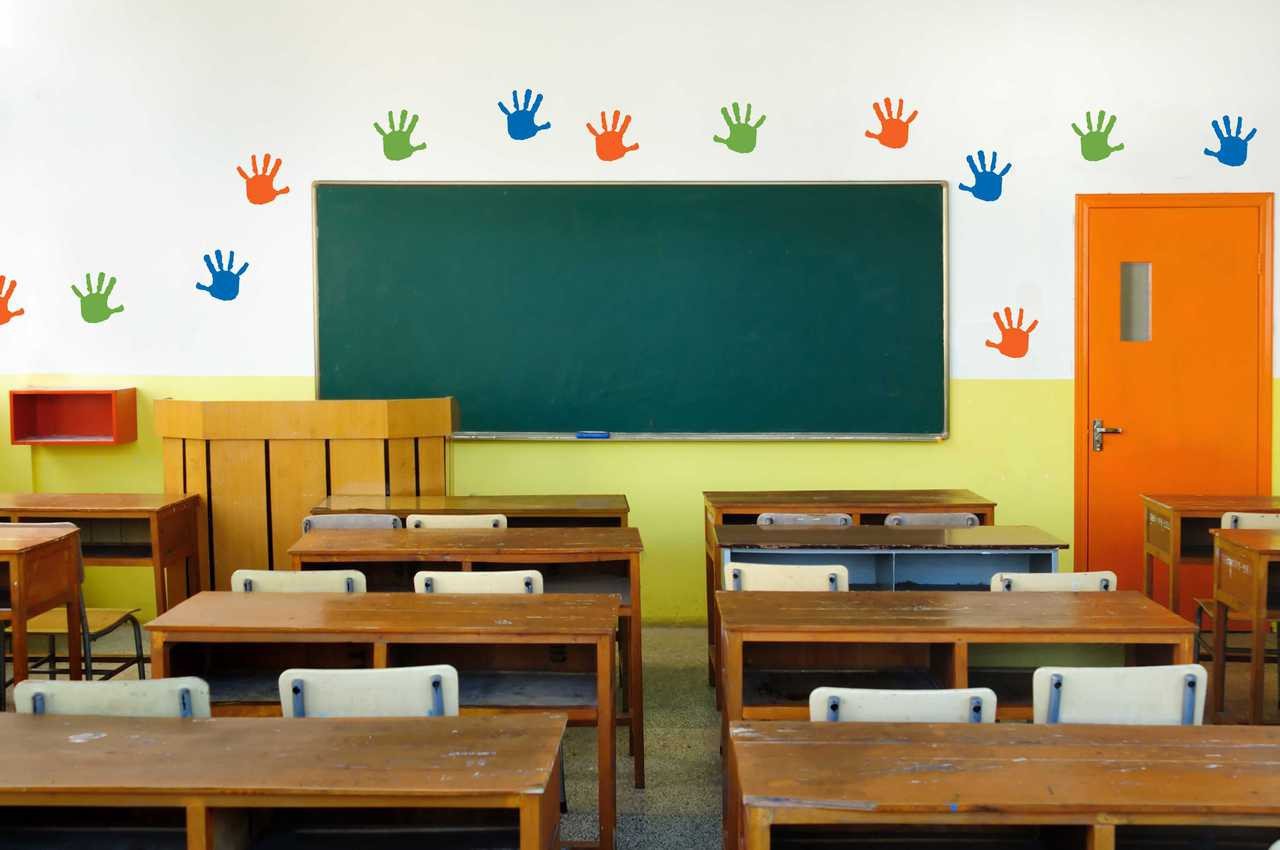 Colorful handprint vinyl wall decals arranged across a classroom wall