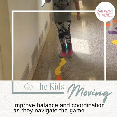 A child walking the heel to toe footprint decals on a school hallway floor