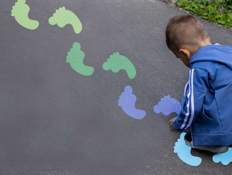 Let's Move footprints sensory path stencil painted on playground pavement