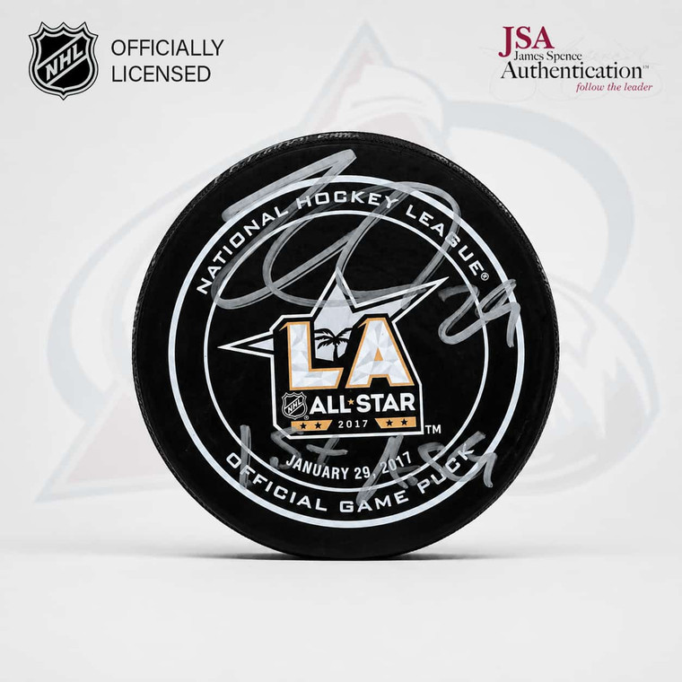 Front view of the Nathan MacKinnon autographed 2017 NHL All-Star Game puck featuring his silver signature, “1st ASG” inscription and LA All-Star logo.