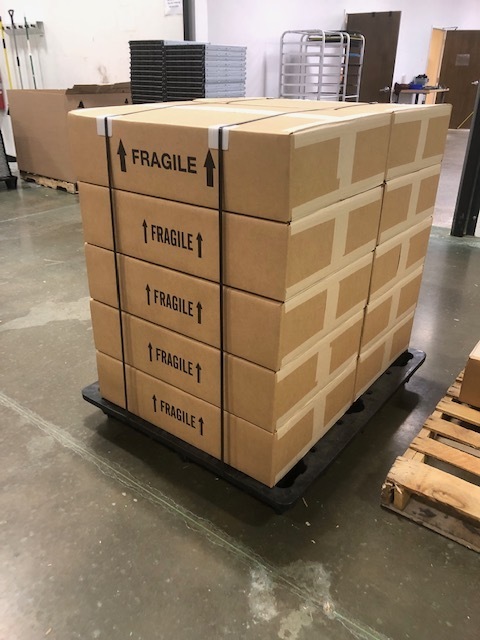 A stack of brown boxes tied together labeled 