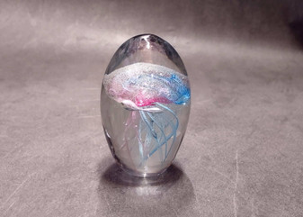 Jellyfish Glass Egg Light Blue Pink Paperweight Glow In The Dark (1 figurine approx. 3.5 inches tall). Copyright 2025 SeaShellSupply.com.