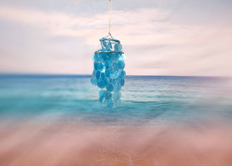 Turquoise Capiz Shell Wind Chime Chandelier (1 Chime approx. 10 x 5 inches) Turquoise Capiz Shell Wind Chime for beachside home charm! Copyright 2025 SeaShellSupply.com.\n\n