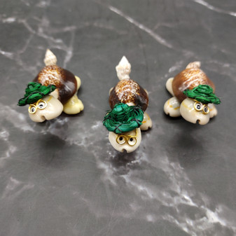 Cowrie Shell Sea Turtle Figurines Green Hat (3 figures approx. 2+ inches) Cute Cowrie Seashell Sea Turtles for gifts decor & display! Copyright 2025 SeaShellSupply.com