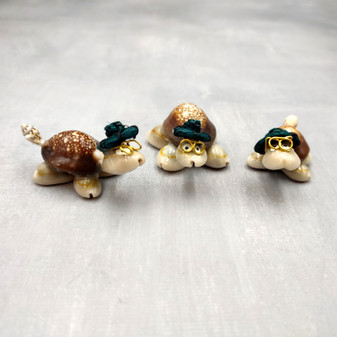 Cowrie Shell Sea Turtle Figurines Dark Green Hat (3 figures approx. 2+ inches) Cute Cowrie Seashell Sea Turtles for gifts decor & display! Copyright 2025 SeaShellSupply.com