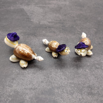 Cowrie Shell Sea Turtle Figurines Purple Hat (3 figures approx. 2+ inches) Cute Cowrie Seashell Sea Turtles for gifts decor & display! Copyright 2025 SeaShellSupply.com.