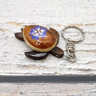 Purple Hibiscus Painted Wooden Sea Turtle Keychain (1 keychain approx. 4.25+ inches) Wooden Sea Turtle Key Fob for gifting or party favors! Copyright 2025 SeaShellSupply.com.