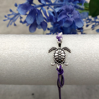 Sea Turtle Charm Bracelet Lavender Purple White Cord (approx. 5-7+ inches AROUND) Purple Sea Turtle String Bracelet Jewelry for gifting! Copyright 2025 SeaShellSupply.com.
