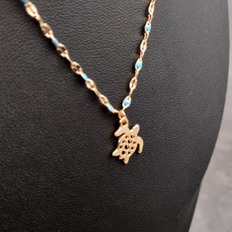 Sea Turtle Necklace Blue Gold Color (1 necklace approx. 16+ inches AROUND) Gold Tone Light Blue Sea Turtle charm necklace for gifting! Copyright 2025 SeaShellSupply.com.