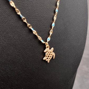 Sea Turtle Necklace Blue Gold Color (1 necklace approx. 16+ inches AROUND) Gold Tone Light Blue Sea Turtle charm necklace for gifting! Copyright 2025 SeaShellSupply.com.