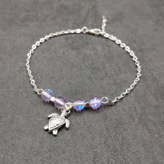 Sea Turtle Anklet Purple Beads Silver Color (approx. 9+ inches AROUND) Cute Light Purple Sea Turtle Charm Anklet for any beachy outfit! Copyright 2025 SeaShellSupply.com.