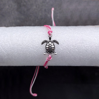 Sea Turtle Charm Bracelet Pink White Cord (approx. 5-7+ inches AROUND) Rose Carnation Sea Turtle String Bracelet Jewelry a thoughtful gift! Copyright 2025 SeaShellSupply.com.