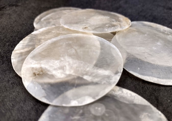 Capiz Shells - (10 shells 2 inch Round Cut). Multiple semi translucent shells in small pile. Copyright 2024 SeaShellSupply.com.