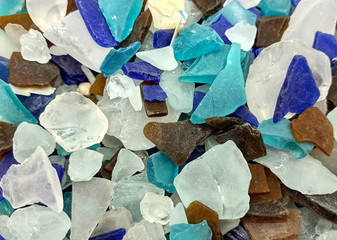 Beach Glass - Medium Tumbled Rough Brown, White & Blue Pacific Assorted - (approx. 1 Kilogram/2.2 lbs. .5-1.25 inches). Multiple blue, white, and brown fragments in a pile. All different shapes and sizes. Copyright 2025 SeaShellSupply.com.