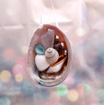 Abalone Frosted Sea Glass Ornament (1 star approx. 3-4 inches) on green background. Copyright 2025 SeaShellSupply.com.