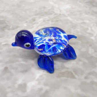 Swirl Glass Sea Turtle Figurine Blue (1 sea turtle figure approx. 1.5 inches) Swirly Blue Glass Sea Turtle for gifts décor & collecting! Copyright 2025 SeaShellSupply.com.