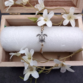 Sea Turtle Charm Bracelet Taupe Beige White Cord (approx. 5-7+ inches AROUND) Tan white Sea Turtle Cord Bracelet great for gifting! Copyright 2025 SeaShellSupply.com.