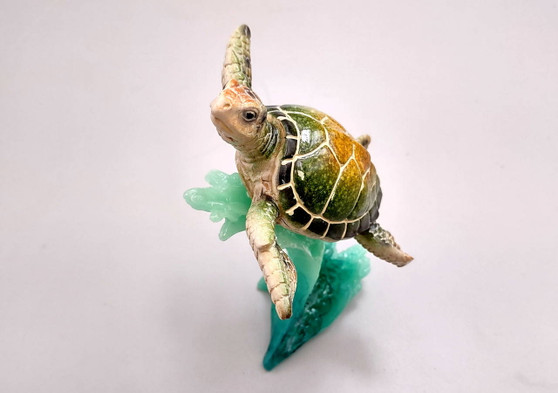 Green Sea Turtle Figurine Riding A Wave (One figure approx. 5+ inches long) Wonderful sea life décor for your home or office! Copyright 2025 SeaShellSupply.com.