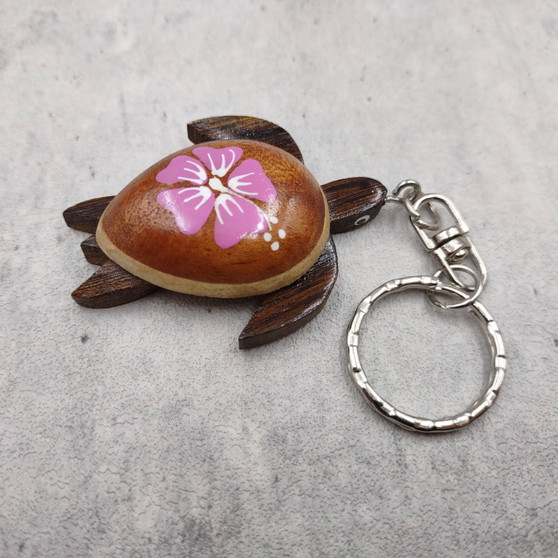 Pink Hibiscus Painted Wooden Sea Turtle Keychain (1 keychain approx. 4.25+ inches) Wooden Sea Turtle Key Fob for gifting or party favors! Copyright 2025 SeaShellSupply.com.