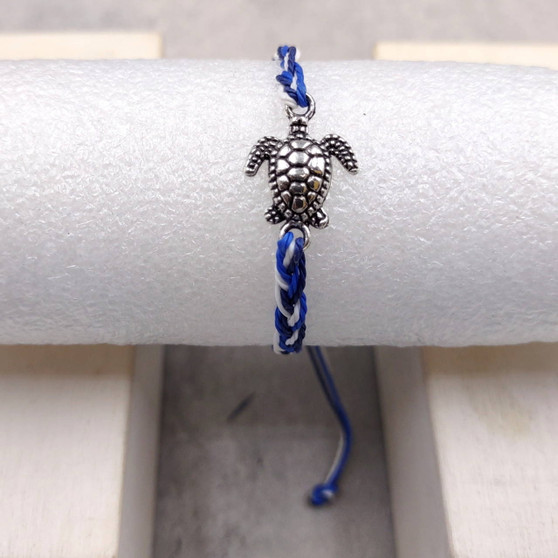 Sea Turtle Bracelet Braided Cord Navy Blue White (approx. 5-7+ inches AROUND) Navy Royal Blue White Knit String Sea Turtle Bracelet to gift! Copyright 2025 SeaShellSupply.com.