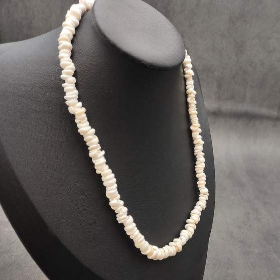 White Puka Shell Necklace - (1 necklace 18 inches x 4-5mm) on grey background. Copyright 2026 SeaShellSupply.com.
