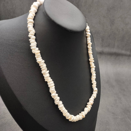 White Puka Shell Necklace - (1 necklace 18 inches x 4-5mm) on grey background. Copyright 2026 SeaShellSupply.com.\n
