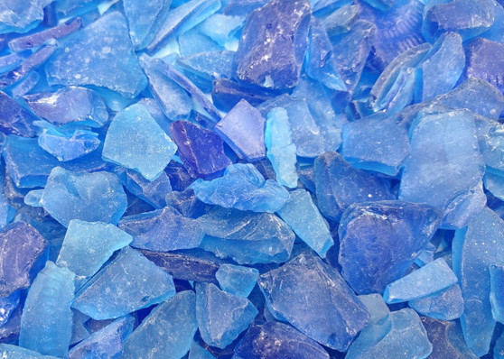 Beach Glass - Medium Tumbled Rough Cobalt Blue - (approx. 1 Kilogram/2.2 lbs. .5-1.25 inches). Multiple shaded blue tiles in a pile, all are different sizes and shapes. Copyright 2025 SeaShellSupply.com.
