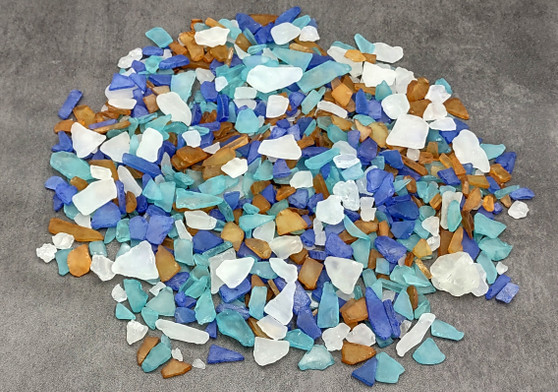 Beach Glass - Small Tumbled Rough Brown, Blue & White Pacific Assorted - (approx. 1 Kilogram/2.2 lbs. .25-1 inches). Multiple colorful different sized mosaic glass sheets in a pile. Copyright 2022 SeaShellSupply.com.