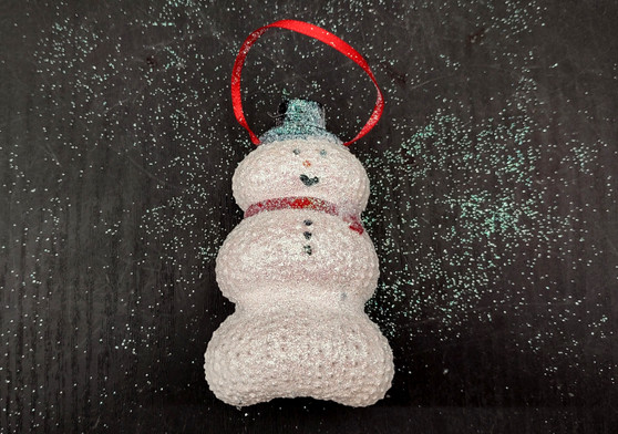 Sea Urchin Snowman Ornament (1 urchin snowman approx. 3-4 inches) on green background. Copyright 2024 SeaShellSupply.com.