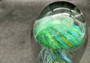 Jellyfish Glass Egg Green Yellow Blue Paperweight Glow In The Dark (1 figurine approx. 4.5 inches tall) Glass Sea Jellies make great gifts! Jellyfish Glass Egg Green Yellow Blue Paperweight Glow In The Dark (1 figurine approx. 4.5 inches tall) Glass Sea Jellies make great gifts!