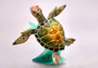 Green Sea Turtle Figurine Riding A Wave (One figure approx. 5+ inches long) Wonderful sea life décor for your home or office! Copyright 2025 SeaShellSupply.com.