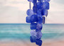 Blue Capiz Round Cut Seashell Wind Chime (1 chime approx. 18 x 5 inches) Round Dark Blue Capiz Shell Wind Chime for coastal home decoration! Copyright 2025 SeaShellSupply.com.
