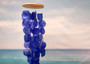 Blue Capiz Round Cut Seashell Wind Chime (1 chime approx. 18 x 5 inches) Round Dark Blue Capiz Shell Wind Chime for coastal home decoration! Copyright 2025 SeaShellSupply.com.