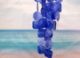 Blue Capiz Round Cut Seashell Wind Chime (1 chime approx. 18 x 5 inches) Round Dark Blue Capiz Shell Wind Chime for coastal home decoration! Copyright 2025 SeaShellSupply.com.