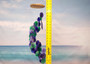 Purple Green Spiral Capiz Shell WInd Chime (1 Chime approx. 23 x 5 inches) Green Purple Capiz Wind Chime brings beachside charm to any home! Copyright 2025 SeaShellSupply.com.