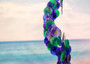Purple Green Spiral Capiz Shell WInd Chime (1 Chime approx. 23 x 5 inches) Green Purple Capiz Wind Chime brings beachside charm to any home! Copyright 2025 SeaShellSupply.com.