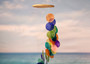 Rainbow Spiral Round Cut Capiz Wind Chime (1 chime approx. 25 x 5 inches) Colorful Capiz Shell Wind Chime adding coastal charm to any home! Copyright 2025 SeaShellSupply.com.