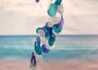 Spiral Blue Turquoise White Capiz Wind Chime (1 chime approx. 26 x 5.5 inches) Colorful Spiral Capiz Shell Chime for coastal home decor! Copyright 2025 SeaShellSupply.com.