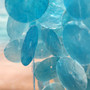 Turquoise Capiz Shell Wind Chime Chandelier (1 Chime approx. 10 x 5 inches) Turquoise Capiz Shell Wind Chime for beachside home charm! Copyright 2026 SeaShellSupply.com.