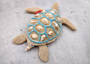 Sandy Sea Turtle Figure With Seashells Net Starfish (1 turtle approx. 5+ inches) Sand Texture Resin Cast Sea Turtle Figure for home decor! Copyright 2025 SeaShellSupply.com.