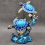 Two Blue Sea Turtles Swimming Sculpture (1 figurine approx. 7+ inches tall) Resin Sea Turtle Pair for coastal home decor & collectibles! Copyright 2025 SeaShellSupply.com.\n
