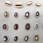 Purple Top Cowrie Seashells (appx. 47-50 pcs.) - Cypraea Annulus. Multiple purple and white ombre shells in pile. Copyright 2024 SeaShellSupply.com.
