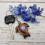 Purple Hibiscus Painted Wooden Sea Turtle Keychain (1 keychain approx. 4.25+ inches) Wooden Sea Turtle Key Fob for gifting or party favors! Copyright 2025 SeaShellSupply.com.