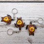 Yellow Hibiscus Painted Wooden Sea Turtle Keychain (1 key fob approx. 4.25+ inches) Wooden Sea Turtle Keychain for gifting or party favors! Copyright 2025 SeaShellSupply.com.
