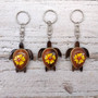 Yellow Hibiscus Painted Wooden Sea Turtle Keychain (1 key fob approx. 4.25+ inches) Wooden Sea Turtle Keychain for gifting or party favors! Copyright 2025 SeaShellSupply.com.