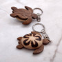 Natural Wood Plumeria Sea Turtle Keychain (1 key chain approx. 4+ inches) Wooden Pattern Sea Turtle Key Fob for gifting or decorative charm! Copyright 2025 SeaShellSupply.com.