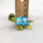 Swirl Glass Sea Turtle Figurine Green Blue (1 figure approx. 1.5 inches) Swirly Green Blue Glass Sea Turtle for gifts décor & collecting! Copyright 2025 SeaShellSupply.com.