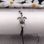 Sea Turtle Charm Bracelet Black Grey White Cord (approx. 5-7+ inches AROUND) Black Grey Sea Turtle String Bracelet Jewelry for gifting! Copyright 2025 SeaShellSupply.com.