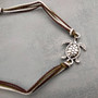 Sea Turtle Charm Bracelet Brown Green White Cord (approx. 5-7+ inches AROUND) Olive Green Brown Sea Turtle String Bracelet Jewelry to gift! Copyright 2025 SeaShellSupply.com.